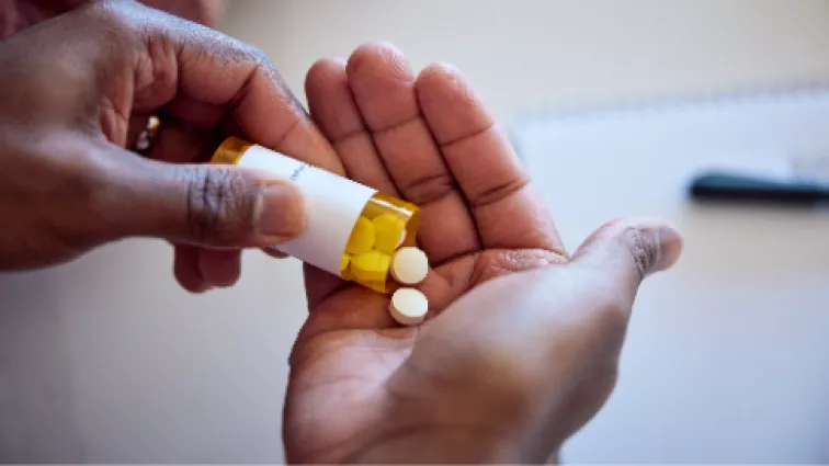 Hands pouring pills