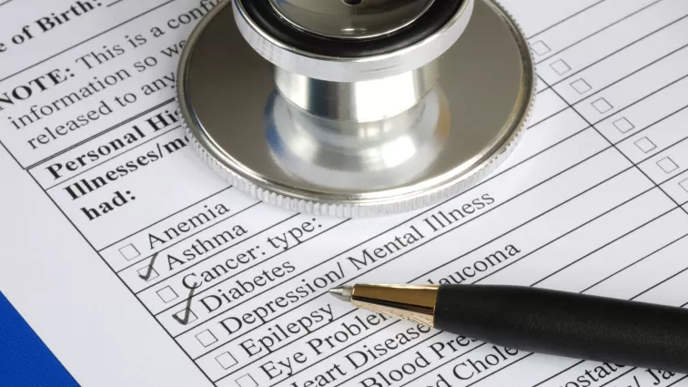 Medical history sheet with pen and stethoscope